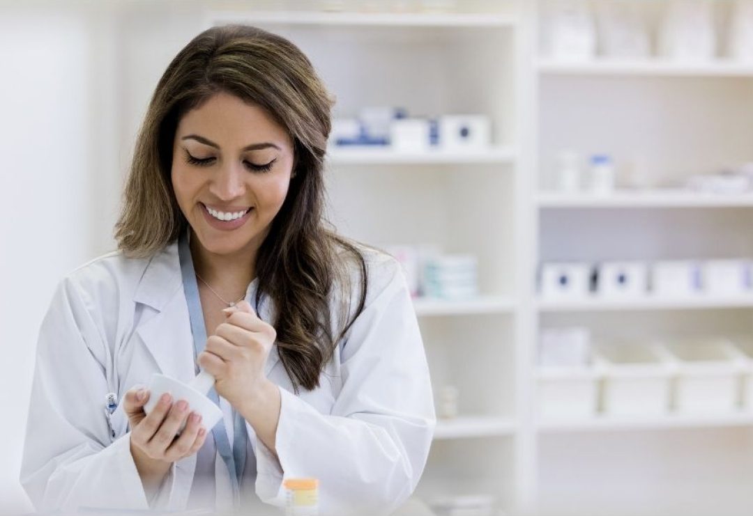 Female Pharmacist working on compounds